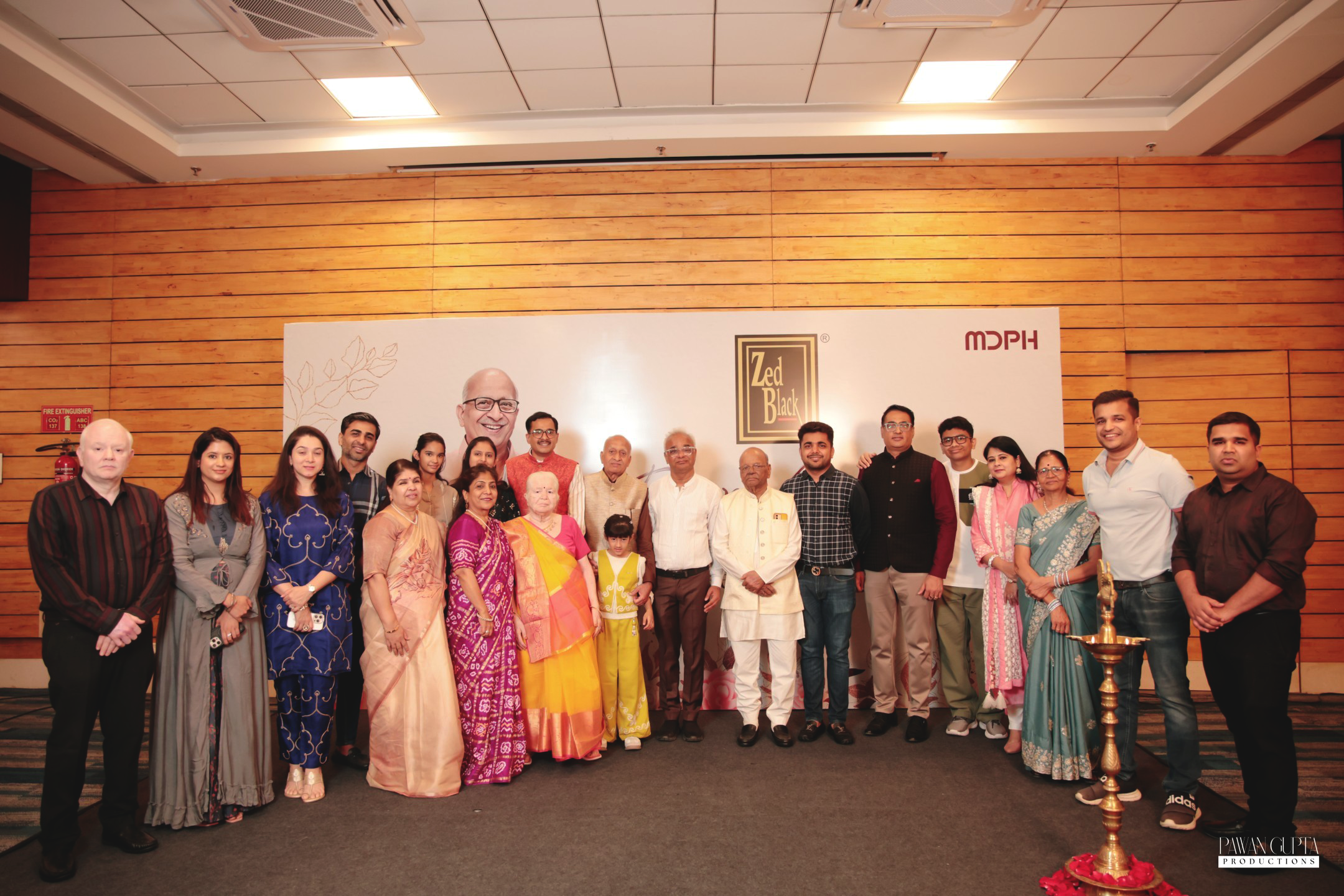 Zed Black commemorative group photograph featuring employees, family members, and dignitaries celebrating the legacy of Mr. Jeevan Kumar Jain at a special felicitation ceremony hosted by MD
